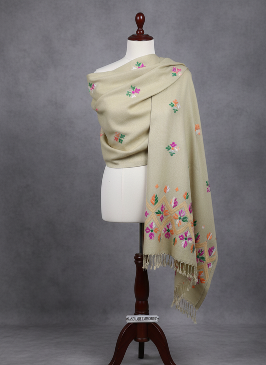 Beige shawl with floral embroidery on a mannequin against a gray background