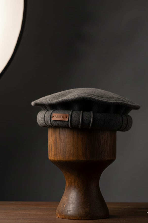 Gray cap on a wooden stand against a dark background